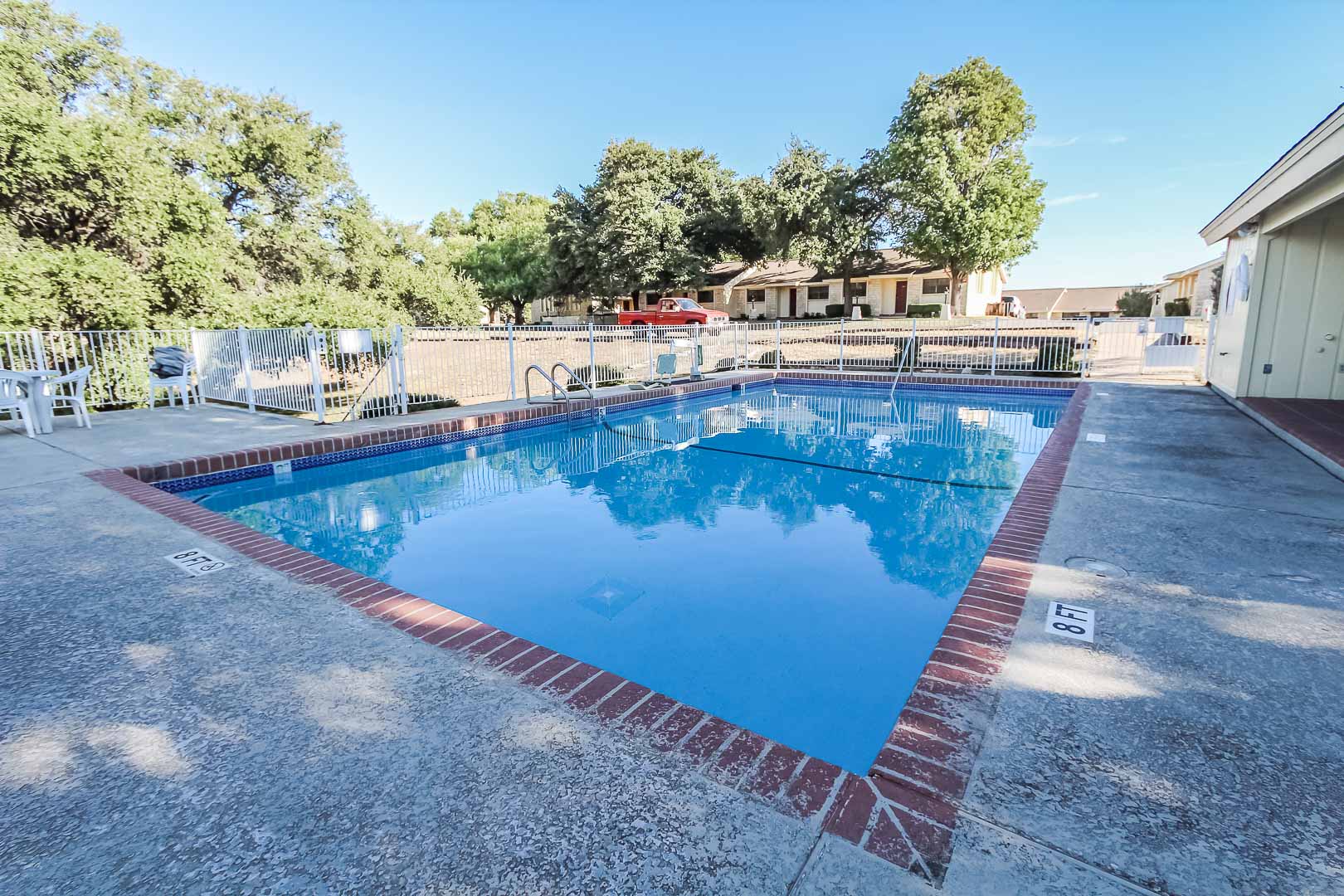 A peaceful outdoor swimming pool at VRI's Vacation Village at Lake Travis in Texas.